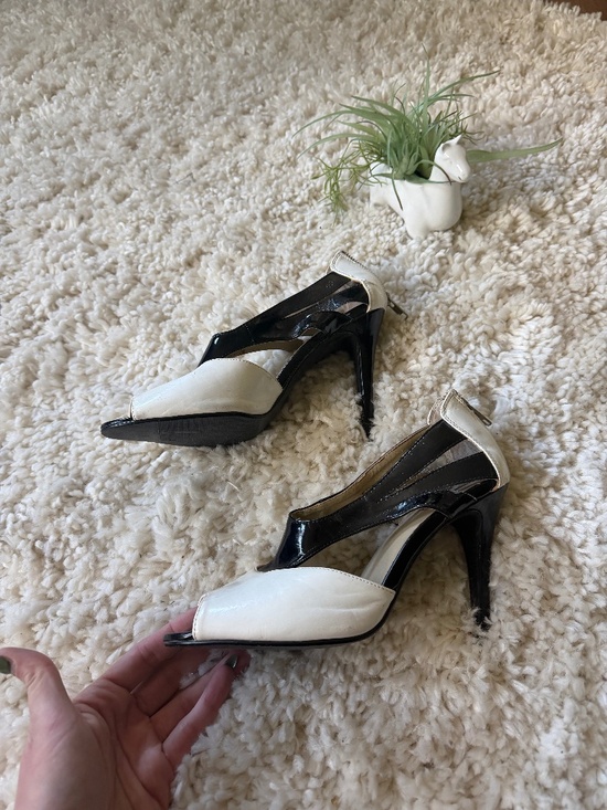 Shoes - Elegant black and white open-toe heels with sculpted ankle straps. Smooth white